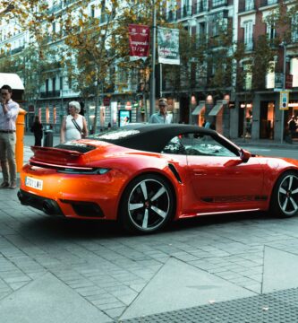 a red sports car parked on the side of the road